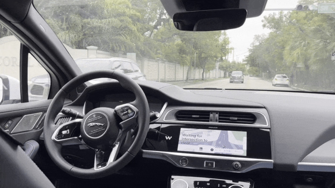 Interior do Waymo, com o assento do motorista vazio.